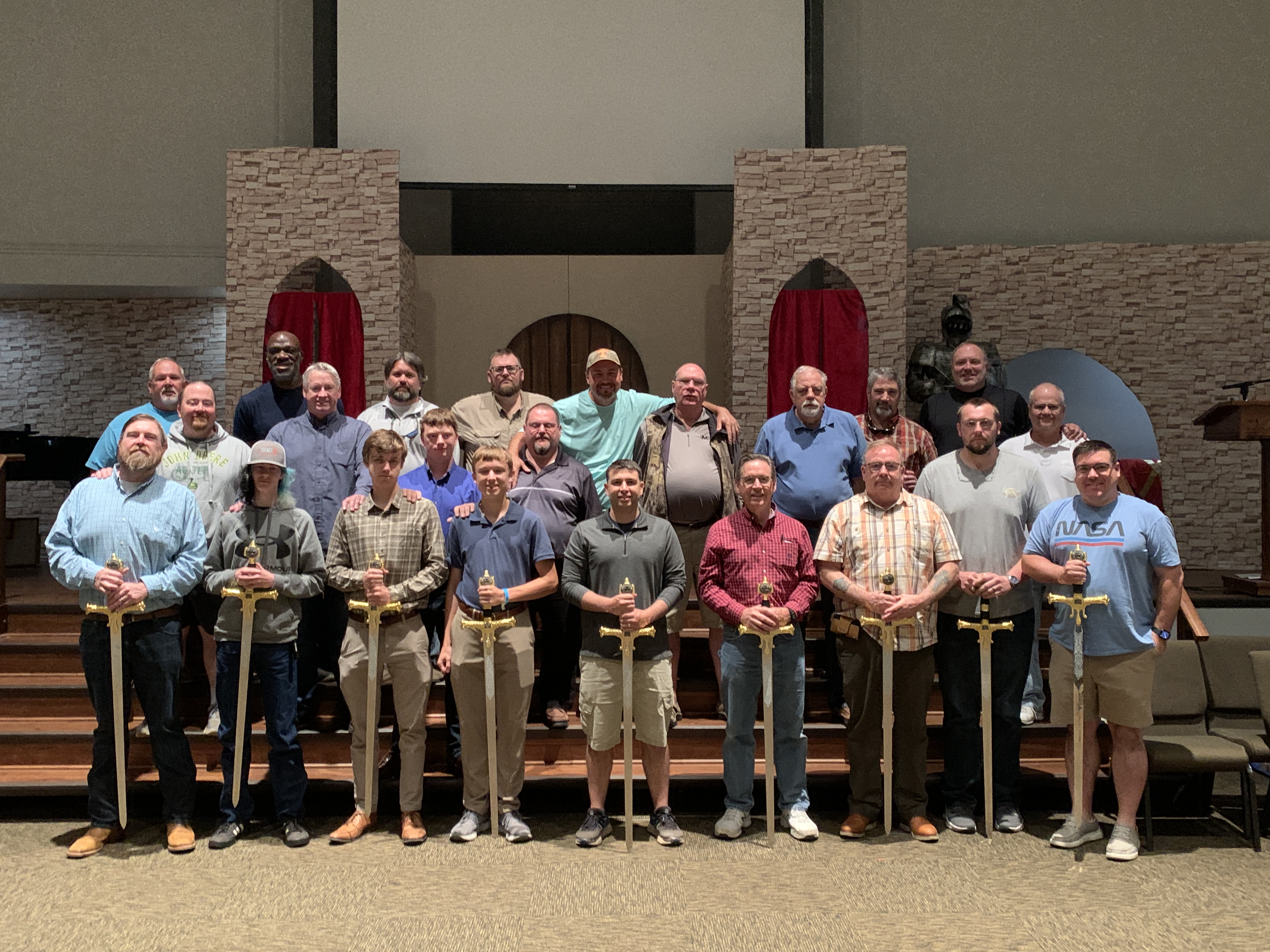 Adult Fight for Manhood participants holding ceremonial swords